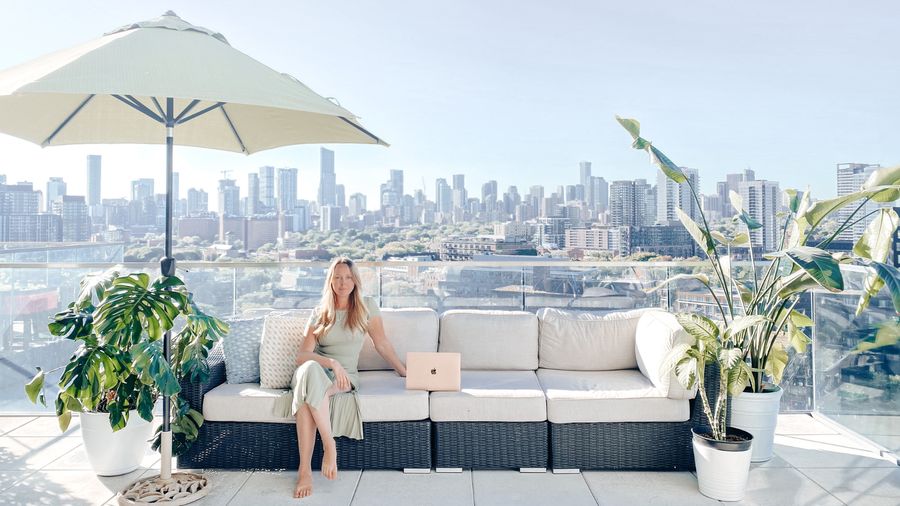Lauren working on a laptop on a rooftop terrace