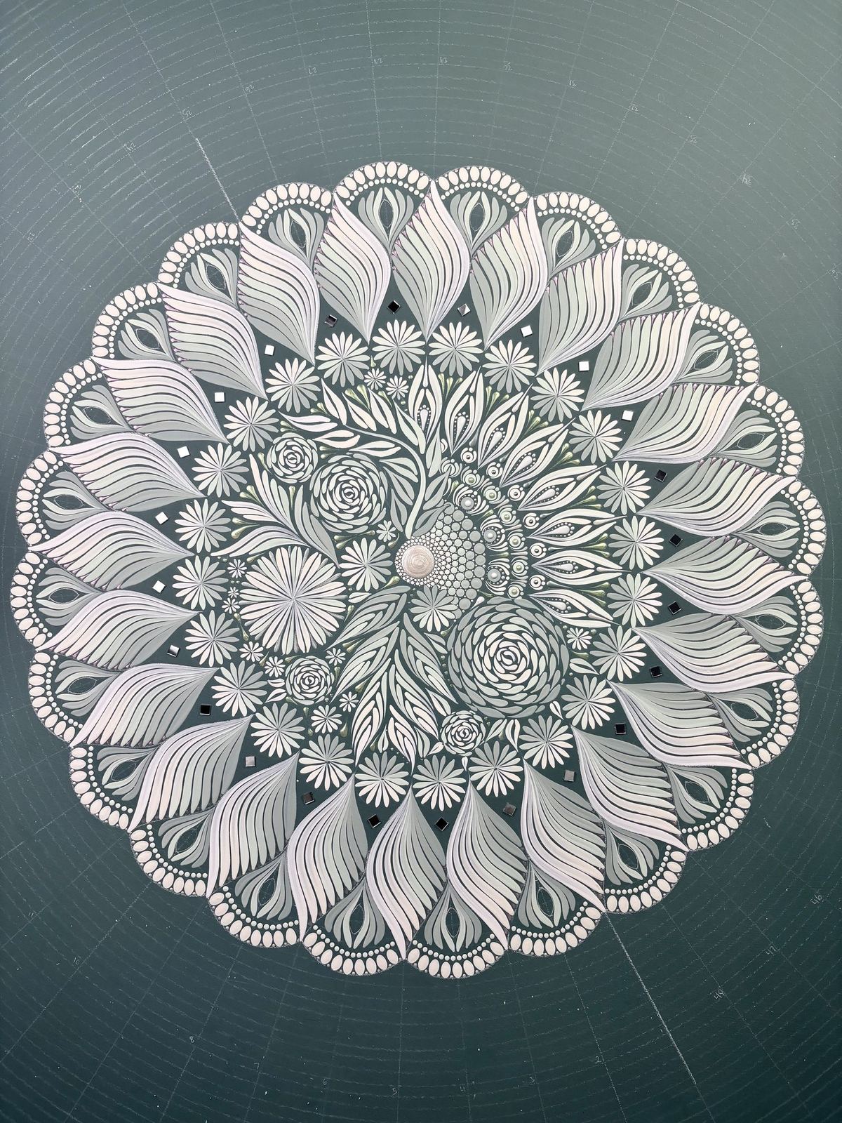 An unpainted, hand-carved mandala design
